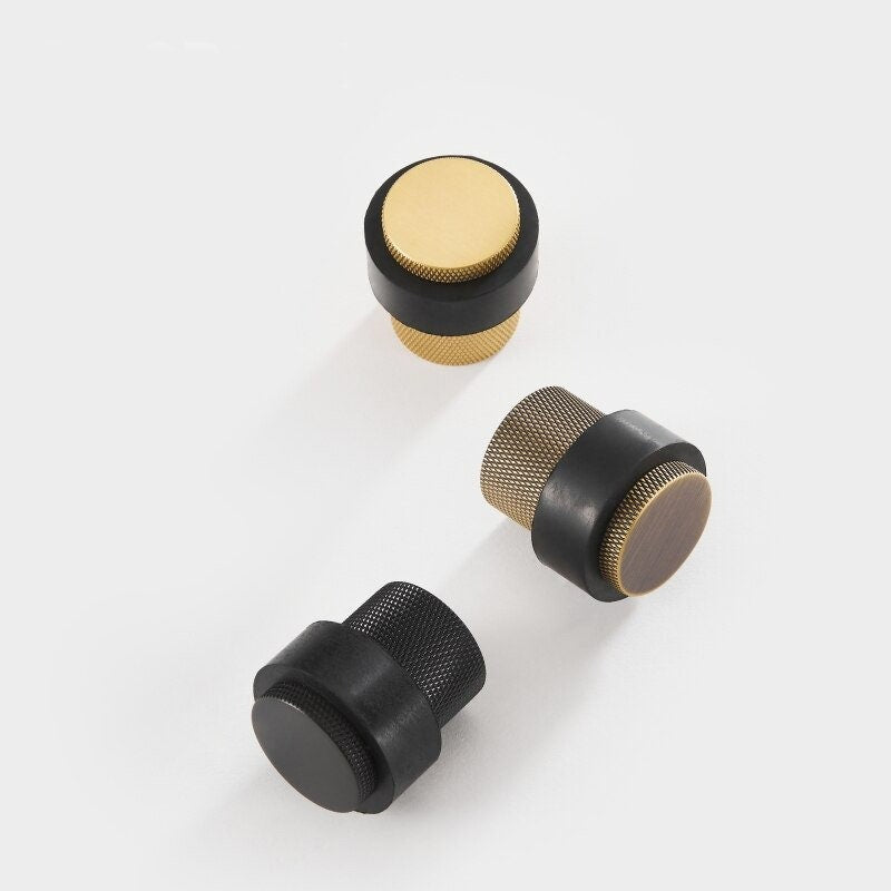 Gold, bronze, and black knurled brass door stops