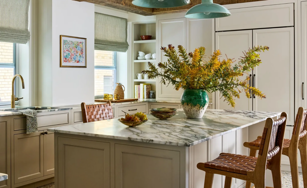 a kitchen with a grey marble kitchen island. 