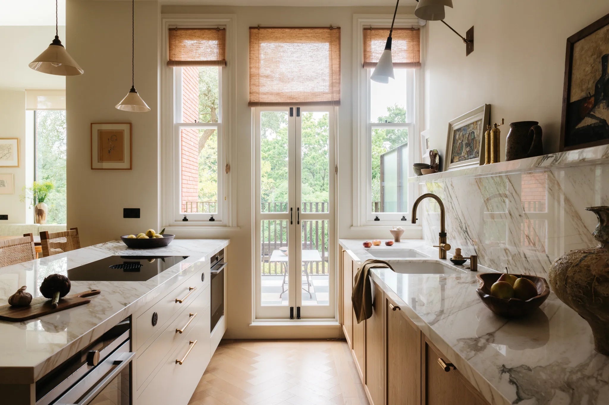 A galley kitchen with wooden cabinets and a marble work surface. 