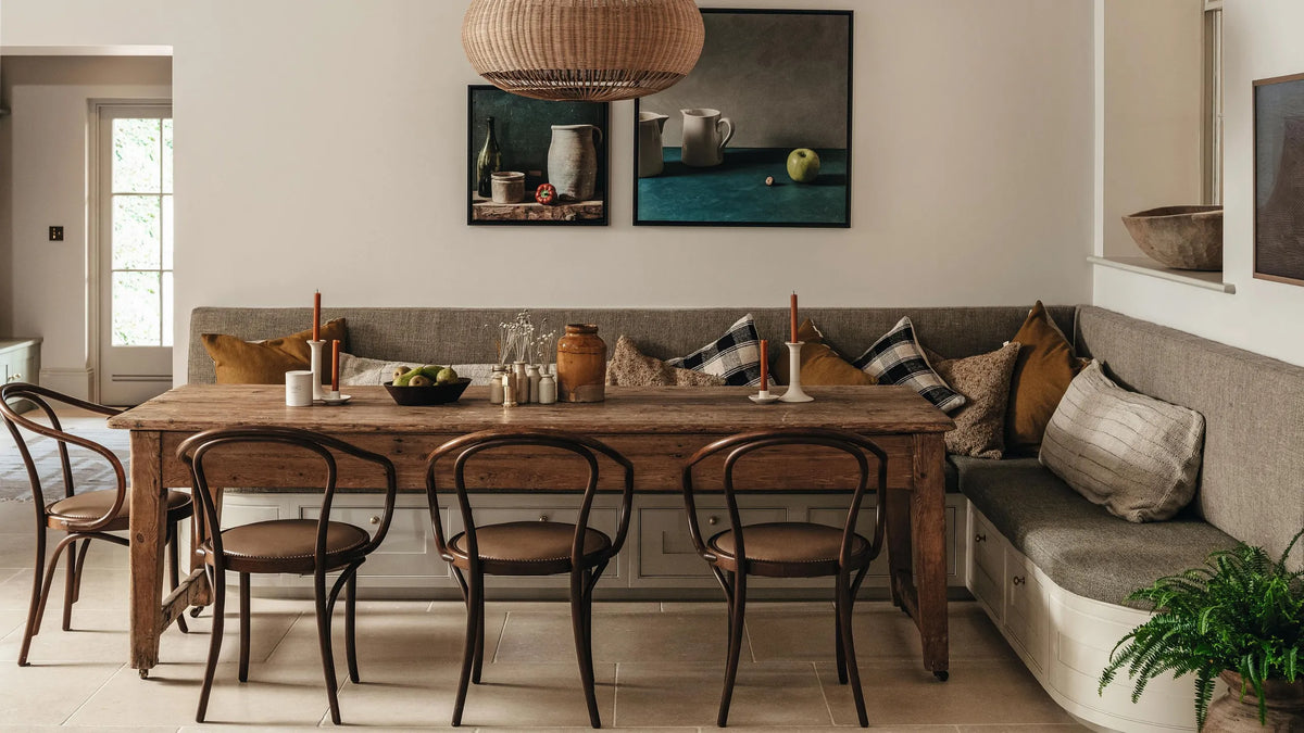 A mushroom coloured dining area with banquette seating. 